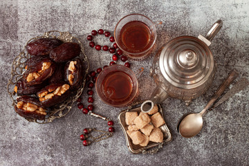Traditional arabic tea with stuffed  dates.Ramadan, Eid concept.Top view. Flat lay.