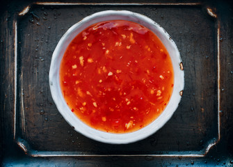 Chinese sweet and sour sauce with chili pepper and garlic in a bowl asian food