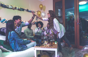 A group of young people celebrating and making party at home