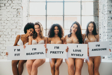 Group of women with different body and ethnicity posing together to show the woman power and strength. Curvy and skinny kind of female body concept