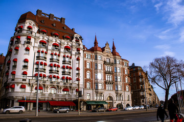 Fototapeta premium View of old architecture buildings on the square in daylight; Clear sky over ancient buildings of old design