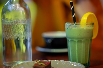 Glass of smoothie at a coffee shop bokeh background