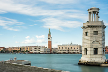 Fototapeta na wymiar Faro San Giorgio Maggiore in front of Campanile and Doge palace in Venice on a sunny day in winter