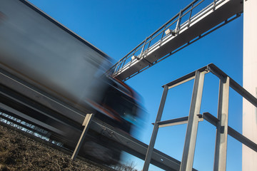 Truck passing through a toll gate on a highway, highway charges, motion blurred image