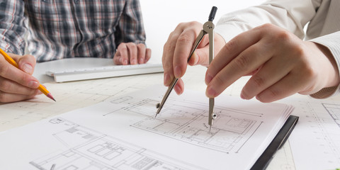 Architects working on blueprint, real estate project. Architect workplace - architectural project,...