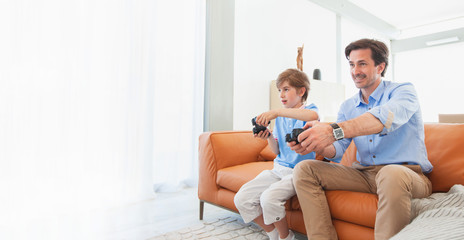 Fototapeta premium Father and son play video game