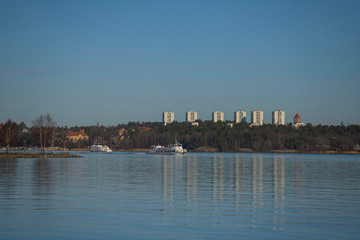 Fototapeta premium View over the district island Lidingö with comuting boats in trafic in Stockholm a winter day