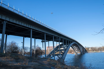 The bridge Västerbron and incoming flight to Bromma airport a sunny winter day in Stockholm