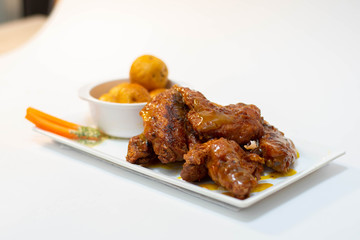 Chicken Wings with vegetables, dip and potatoes on white background 