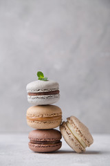 Macarons chocolate, caramel and vanilla on light background