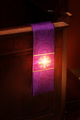 glow of the stole and the cross in the church - obrazy, fototapety, plakaty