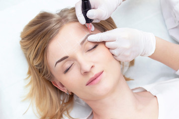 Make-Up. Beautician Hands Doing Eyebrow Tattoo On Woman Face.Permanent Brow Makeup In Beauty Salon. Closeup Of Specialist Doing Eyebrow Tattooing For Female. Cosmetology Treatment.