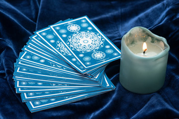 Blue tarot cards on blue velvet cloth background. - obrazy, fototapety, plakaty