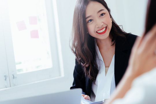 A young attractive asian woman is interviewing for a job. Her interviewers are diverse. Human resources manager conducting job interview with applicants in office