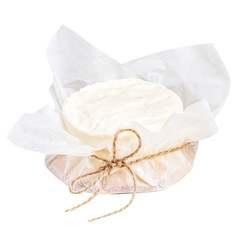White Cheese wheel packaged in a paper isolated on a white background. Organic goat cheese