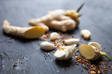 Garlic, species and ginger on a black background. Food ingredients. Cooking concept.Food photo. Fresh natural garlic on black table