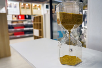 Tillsyn decorative hourglass inside Ikea furniture store on defocused background, copy space