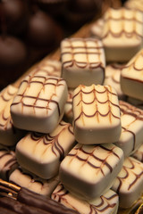 Delicious and tasty sweet bar of white chocolates at a confectionery.