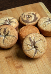 The recipe for making muffins. Ingredients for making muffins. Ready-made baked muffins lie on a wooden board on the table.
