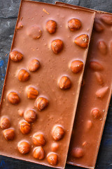 chocolate bar with hazelnut milk or black (sweet dessert) menu concept background. top view. copy spaces