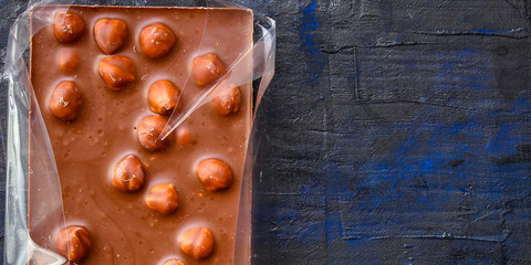 chocolate bar with hazelnut milk or black (sweet dessert) menu concept background. top view. copy spaces