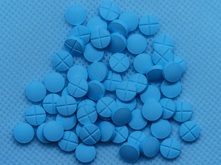White medical  tablets macro photography. Macro top down view. Healthy lifestyles concepts.