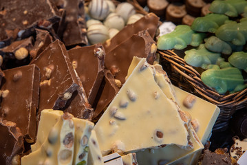 Delicious and tasty sweet bar of dark chocolates with nuts at a confectionery.