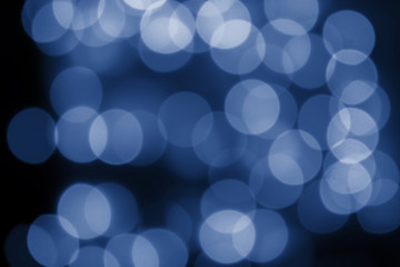 Defocus winding circles from a garland, background backdrop design wallpaper. Beautiful bokeh effect toned in classic blue color