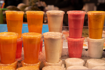 Plastic glasses of blended fresh juices on ice