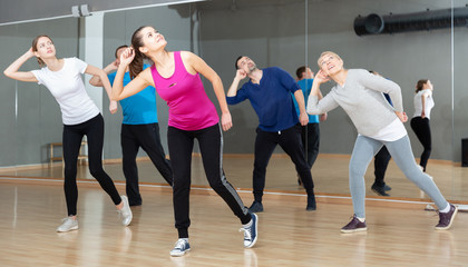 Fototapeta na wymiar Adult people training in dance studio