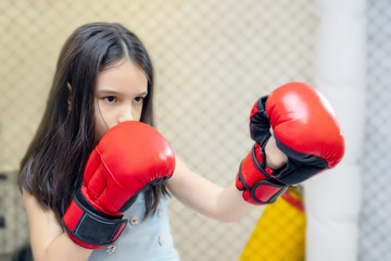 little cute girl in boxing gloves training