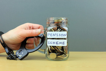 A hand handcuffed to a jar full of cash. Locked into a pension scheme.