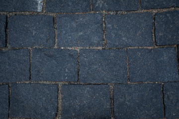 Dark grey stone road texture.