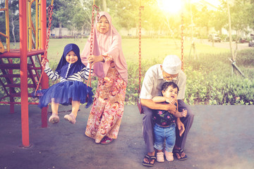 Grandparents playing with their grandkids at park