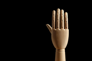 Wooden hand of mannequin for drawing shows five fingers on a black background. High five! Learning to count - five. Side view. Art model for drawing. Part of the body - hand, brush. 