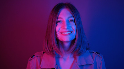 Shy gorgeous young woman with straight hair looking into camera, smiling. Footage of lovely...