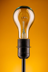Retro lamp on a yellow background. The concept of electricity.
