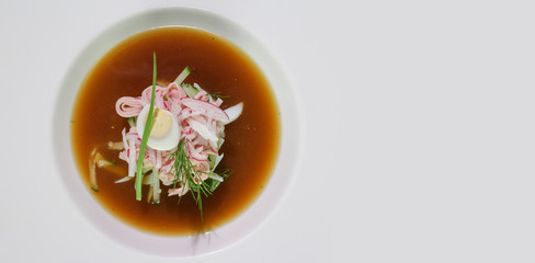 Kvass okroshka in a white plate.Copy space.View from above.Russian cold soup.