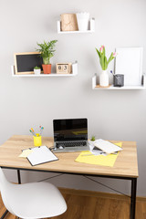 Front view of creative designer desktop with laptop ,notebook , supplies.