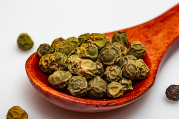 Green pepper peas in a wooden spoon.