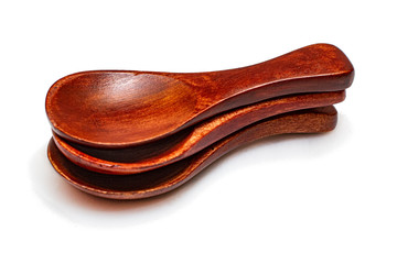 Three tea wooden spoons on a white background.