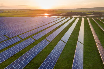 Blue solar photo voltaic panels system producing renewable clean energy on rural landscape and...