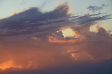 Naklejka na ściany i meble Beautiful clouds lit by the rising sun. Sky.