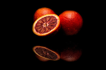 Orange combined with pomegranate on a black background.