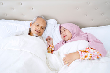 Portrait of elderly Asian muslim couple sleeping