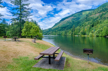 Picnic tables near mountain lake in Vancouver, Canada.