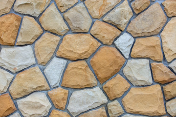 Abstract wall surface made from sand stones for usage as background.