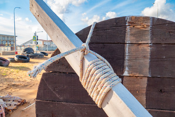 Rope with node. 	Rope knot on wooden beam