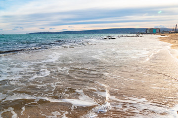 Fototapeta na wymiar Sandy beach with seashells on sea island at high tide