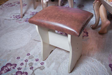 chair stool seat brown . a wooden frame leather cushion stool .